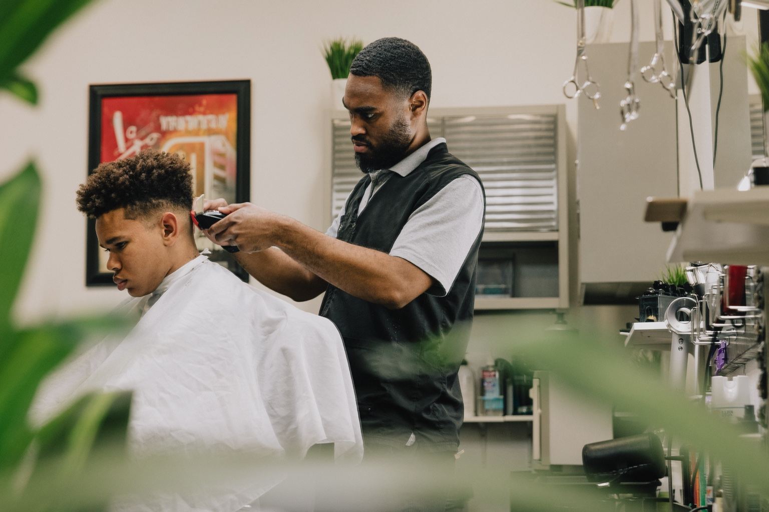 Darius performing a haircut inside the private North Austin barbershop