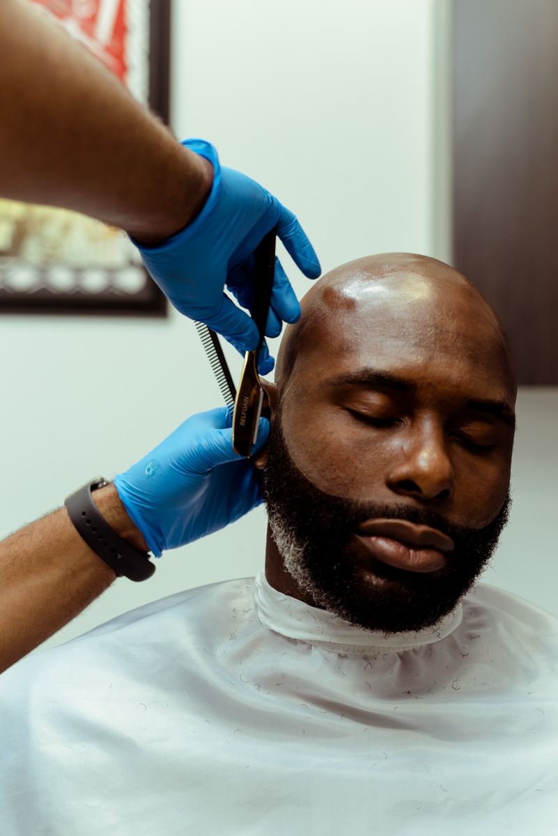 Barber service in progress at Premium Fade League